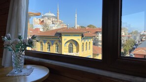A view of a historic building with domes and minarets through a window. - Terrace Guesthouse (Istanbul)