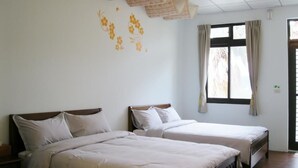 A room with two beds, a window with curtains, and a ceiling with a light fixture. - Fu Chuan Garden Homestay (Nanzhuang)