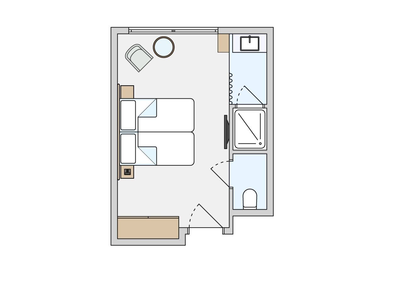 Distribución de una habitación de hotel con cama, escritorio, silla, mesita, sofá y baño con inodoro y lavamanos.