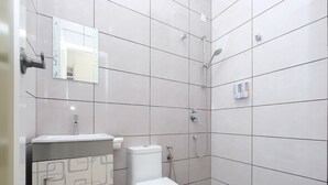A modern bathroom with a toilet, sink, and shower. - Mancalin Hotel (Kuantan)
