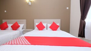 A hotel room with two beds, each with white bedding and red pillows. There is a red and white blanket on the larger bed. - Mancalin Hotel (Kuantan)