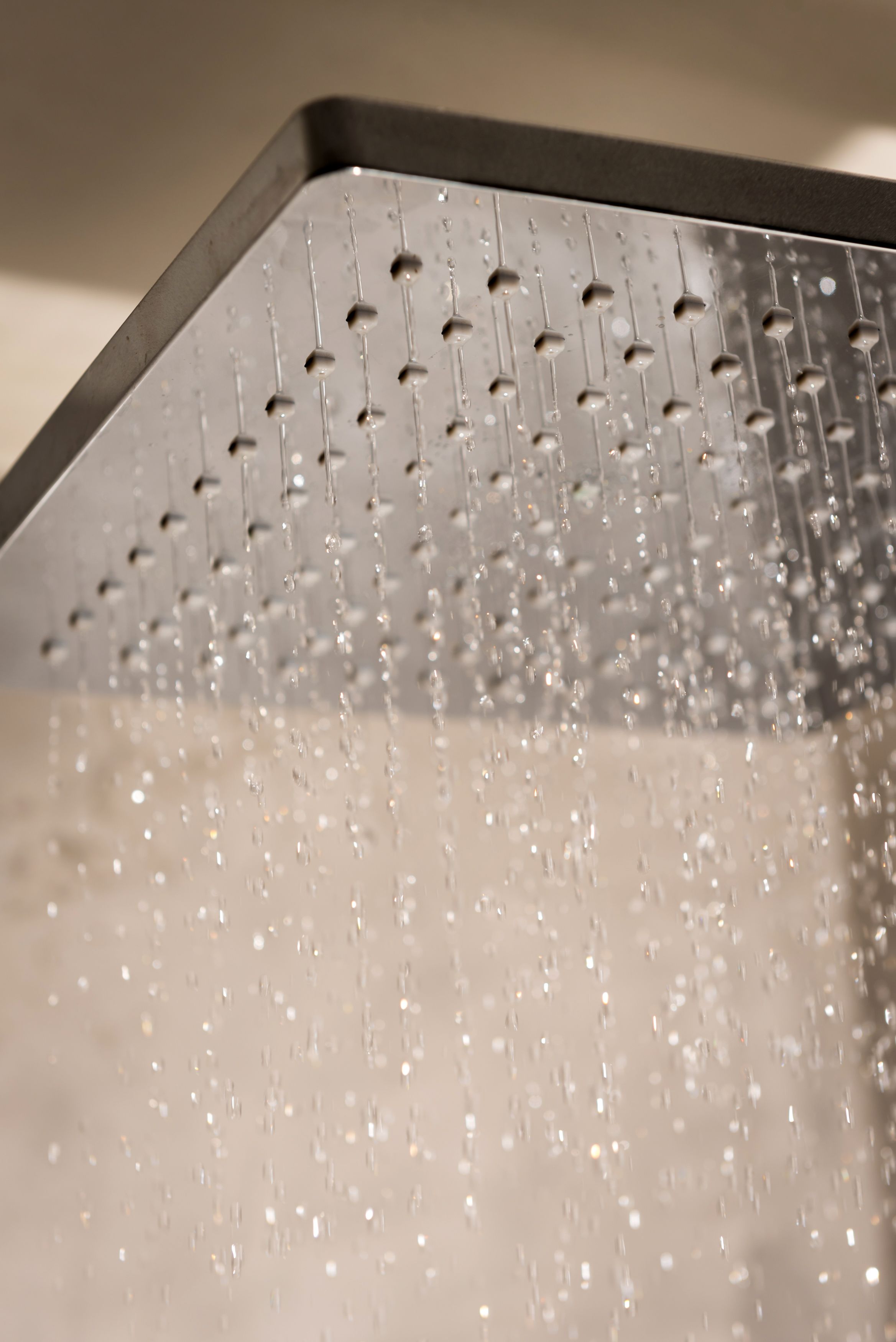 A close-up of a showerhead with multiple water streams.