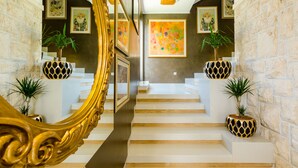 A grand staircase with ornate golden railings, flanked by potted plants and framed artwork. - Villa Dolores Apartments  (Dubrovnik)