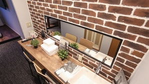 A bathroom with a large mirror, a sink, and a wooden vanity. - TABIGOYA LIFE＆TRIP HAKATA EAST (Fukuoka)