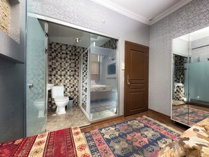 A bathroom with a glass shower enclosure, a toilet, and a sink. - The New Season Apart (Istanbul)