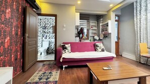 A modern living room with a sofa, a coffee table, and a patterned rug. - The New Season Apart (Istanbul)