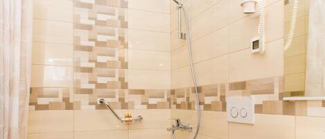 Un baño moderno con ducha, inodoro y lavamanos.