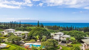 A residential area with houses, a swimming pool, and a view of the ocean. - ONE of Our BEST! Fresh Pricing, UPSCALE Renovations; (22V-1) where you get HUGE OCEAN Views (Lahaina)