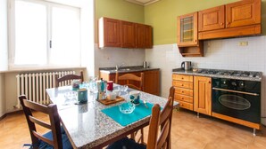 Una cocina con armarios de madera, encimera de granito y horno integrado.