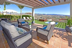 A covered patio with wicker furniture, a small pool, and a view of the mountains. - Terrezas 2 (Maspalomas)