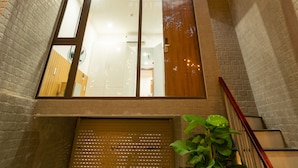 A modern apartment building with a sign reading "Dandelion Apartment." - Dandelion Apartment (Da Nang)