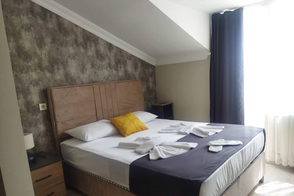 Premium bedding, desk, laptop workspace, blackout drapes