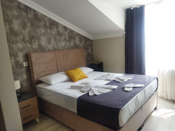 Premium bedding, desk, laptop workspace, blackout curtains