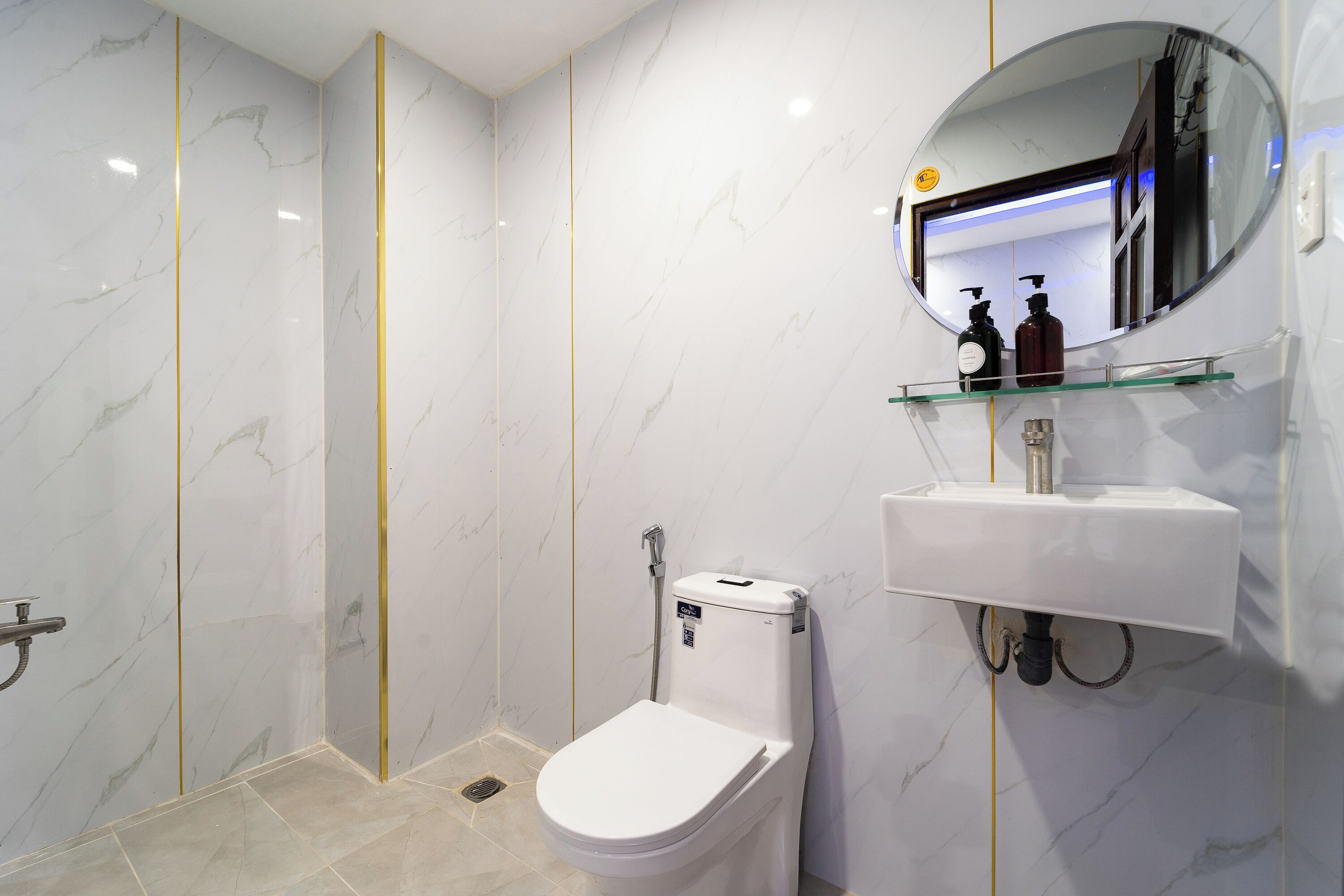A modern bathroom with a toilet, sink, and mirror.