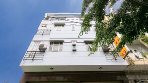 A multi-story building with a white facade, multiple balconies, and a visible ground floor entrance. - OYO 261 Binh Dung Hotel (Ho Chi Minh City)