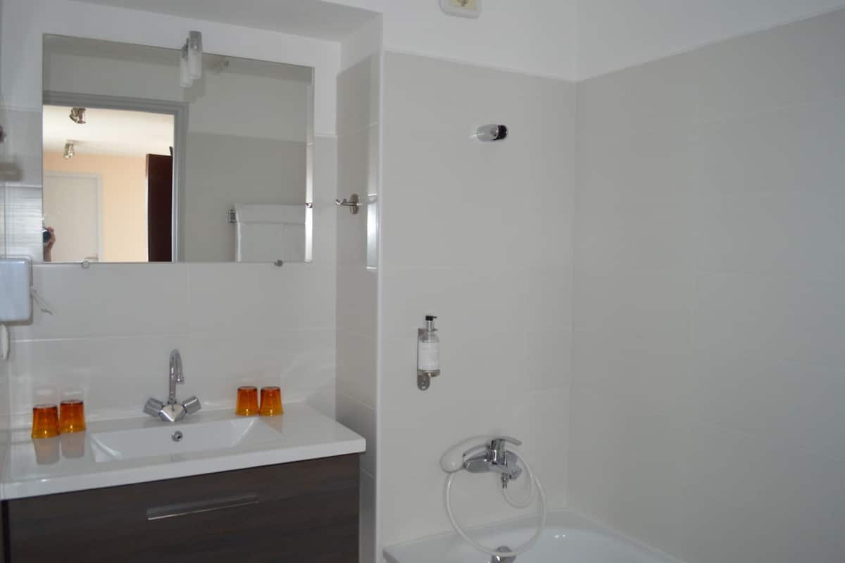 hair dryer, towels, shampoo, toilet paper