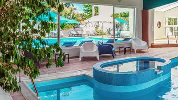 Indoor pool, outdoor pool, pool umbrellas, pool loungers