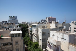 A densely packed urban area with multiple buildings, some with visible air conditioning units and satellite dishes.