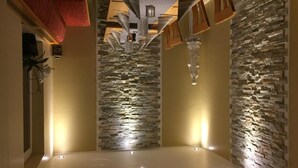 A modern interior with a stone wall, recessed lighting, and a minimalist design. - Moselperle (Traben-Trarbach)