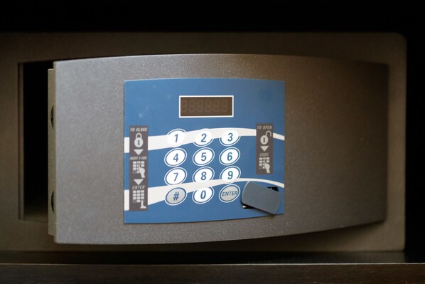 A blue keypad with numbers 0-9 and a few symbols, a display showing '888888', and a small gray object on the keypad. - Hometown Vite (Rome)