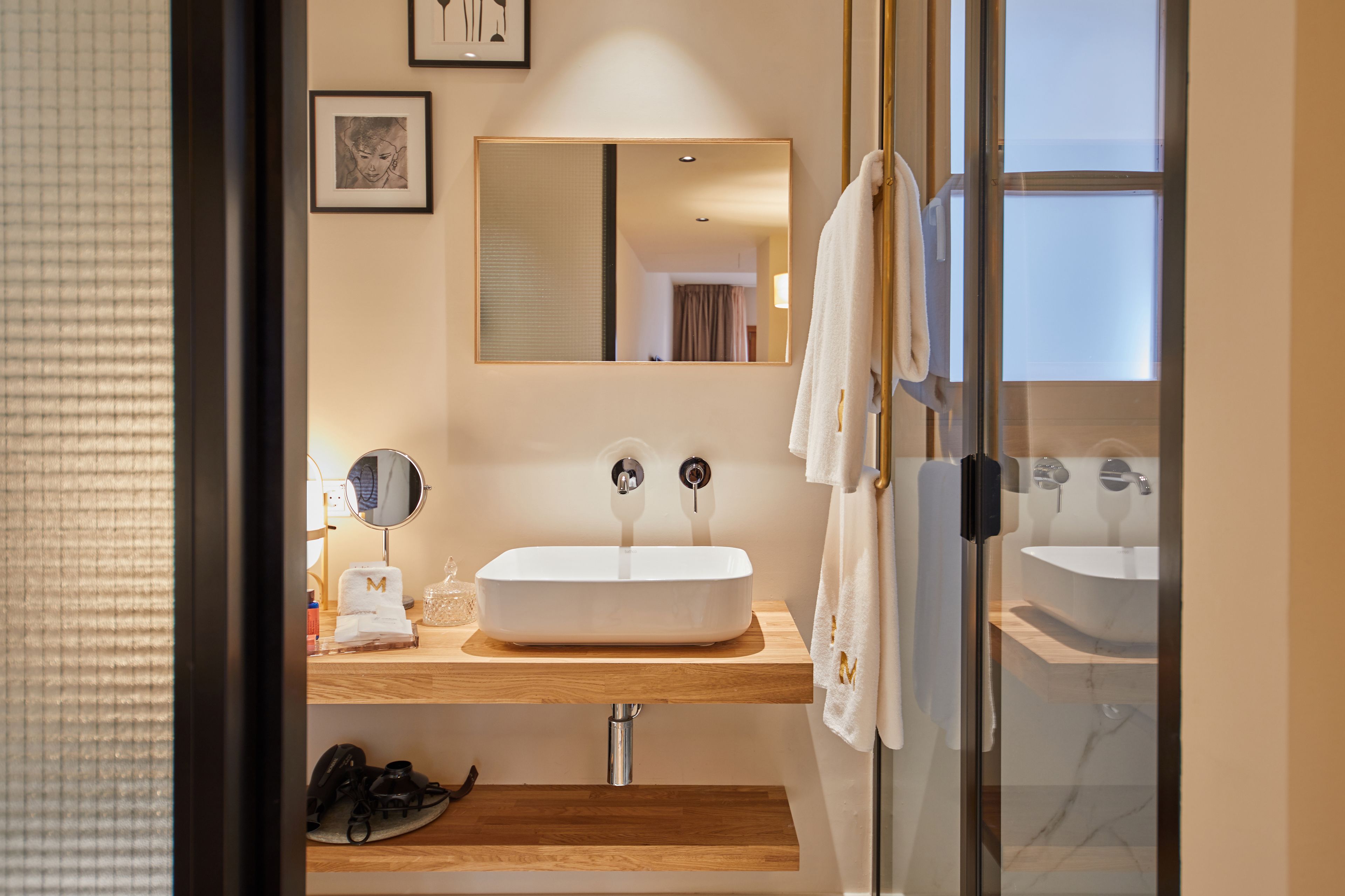 deluxe suite | bathroom | hair dryer, bathrobes, slippers, towels
