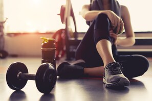 A gym setting with a dumbbell and a water bottle on the floor. - Original Sokos Hotel Tripla (Helsinki)