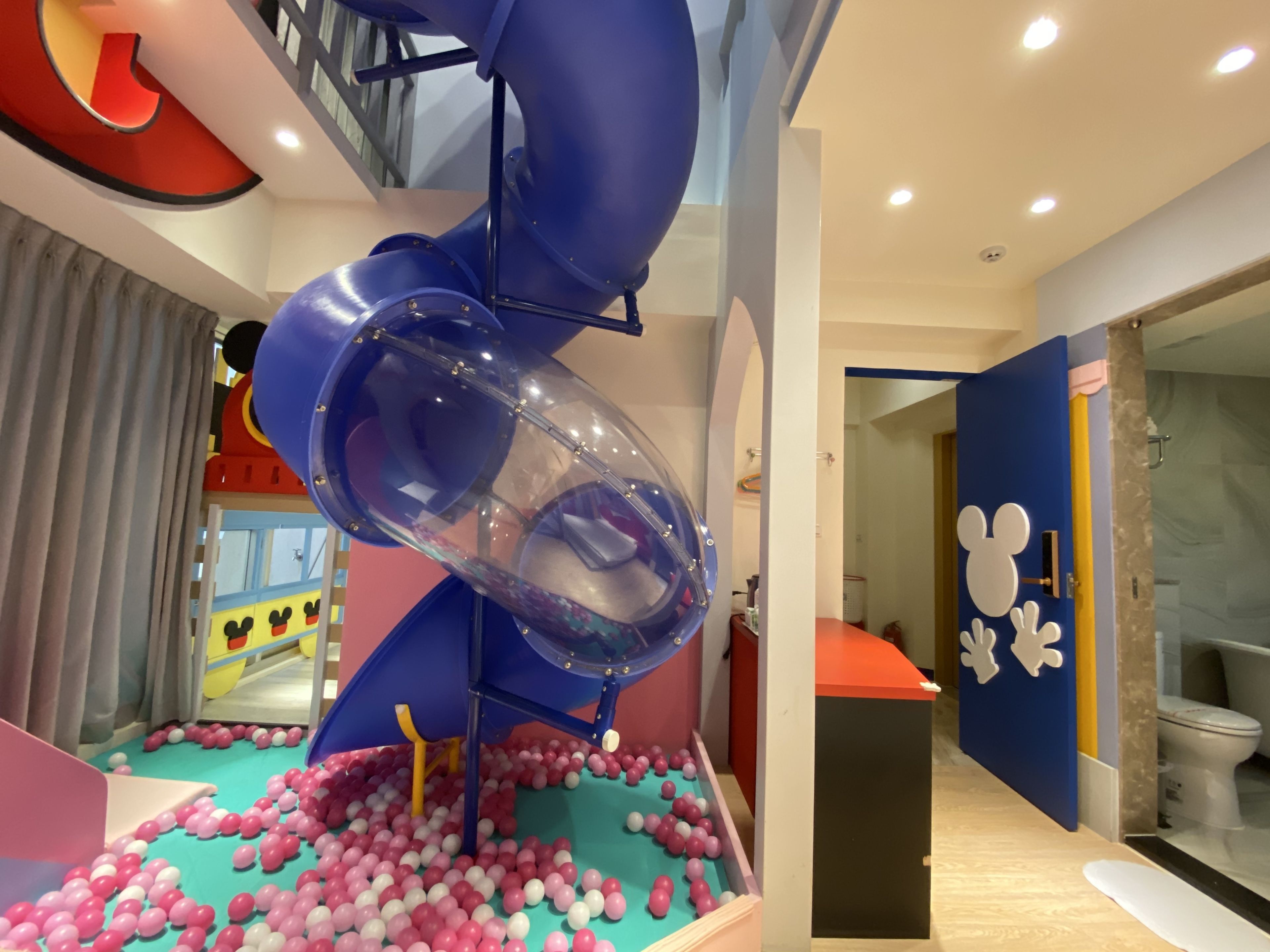 A children's play area with a slide and ball pit.