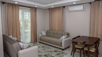 Family Apartment | Living area | 55-inch LED TV with satellite channels, TV