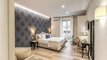 Deluxe Quadruple Room | Minibar, in-room safe, individually decorated, individually furnished