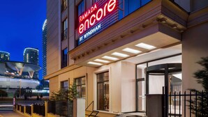 A hotel entrance with a prominent sign reading "RAMADA encore by WYNDHAM". - Ramada Encore By Wyndham Istanbul Basin Express (Istanbul)