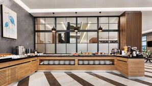 A modern kitchen with a large island, built-in shelves, and a striped floor. - Ramada Encore By Wyndham Istanbul Basin Express (Istanbul)