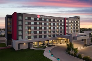A multi-story hotel with a modern design, featuring a prominent logo on the facade. - Best Western Premier Winnipeg East (Winnipeg)