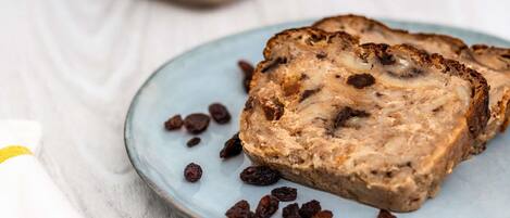 Slices of bread with raisins on a plate.