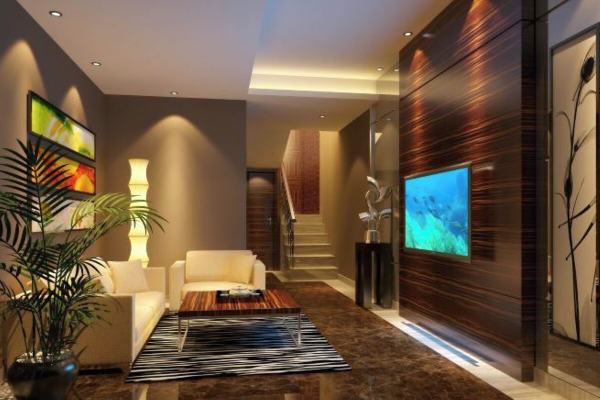 A modern lobby with a sofa, coffee table, and a large flat-screen TV.