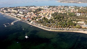 An aerial view of a coastal town with a marina, dense residential area, and a large body of water. - Comfortable 2-star studio near spa, pets allowed (Balaruc-les-Bains)
