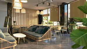 A modern interior with a sofa, chairs, and a dining area.