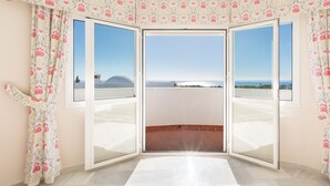 A room with a large sliding glass door leading to a balcony with a clear view of the sea. - Villa Panorama – Ocean View Oasis with Private Pool, Mijas Costa (Mijas Costa)
