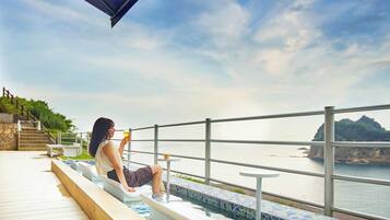 Relax by the pool and take in the serene coastal views.