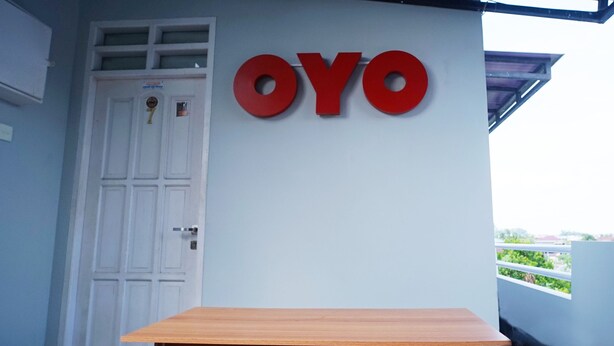 A building with a white door and a large red sign that reads "OYO". - OYO 1007 Alletha Guest House 2 (Balikpapan)