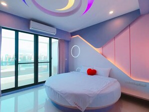 A modern bedroom with a large bed, a view through a large window, and a ceiling with circular light fixtures. - Turn Left B&B (Magong)