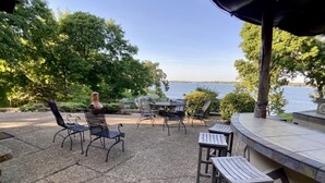 An outdoor patio with seating and a view of a lake. - Waterfront home with dock!




 (Afton)