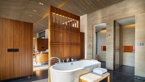 A modern bathroom with a freestanding bathtub, wooden paneling, and a minimalist design. - Ahn Luh Zhujiajiao (Shanghai)