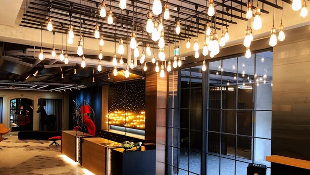 Eine moderne Lobby mit einer Rezeption, einem Postfach und einem großen Fenster.