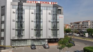 A modern hotel building with the name "HOTEL EMMA EST" prominently displayed. - Hotel Emma Est (Craiova)