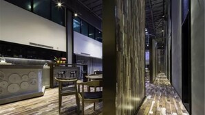 A modern interior with a bar area, wooden flooring, and a long corridor with a patterned floor. - M Do Hotel (Weifang)