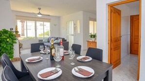 A dining area with a table set for six, a ceiling fan, and a view to the outside. - Lucy Moraira House for 6 people (Moraira)