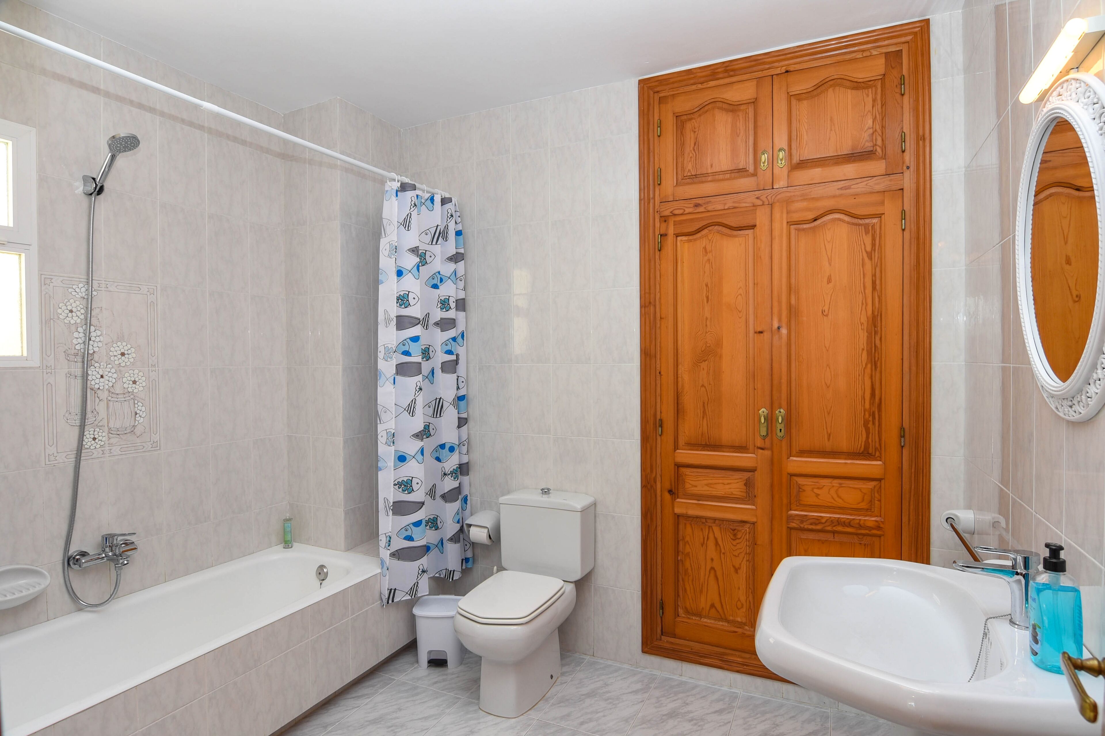 A bathroom with a bathtub, toilet, shower, and sink.