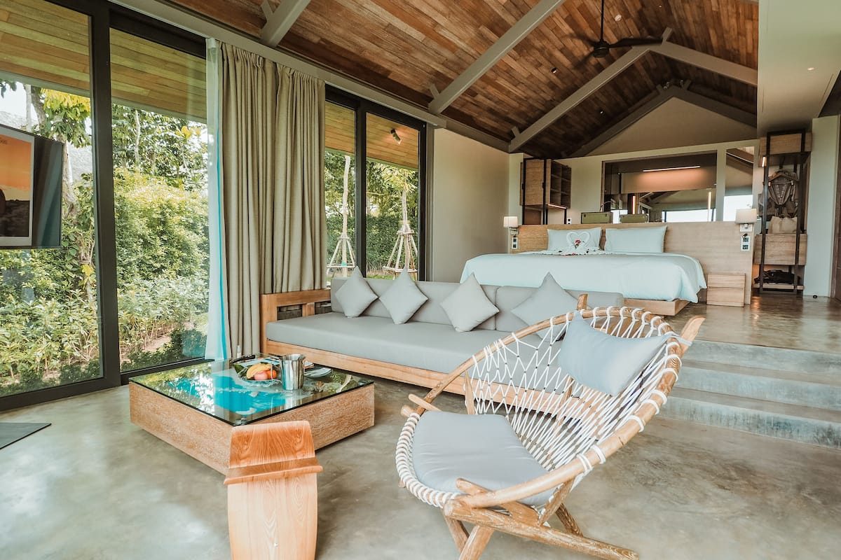 one-bedroom pool villa with round-trip boat transfer | living area | 49-inch smart tv with satellite channels, tv