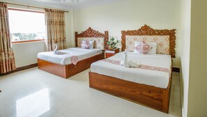A hotel room with two wooden beds, a large window with curtains, and a ceiling with recessed lighting. - VY CHHE Hotel (Battambang)