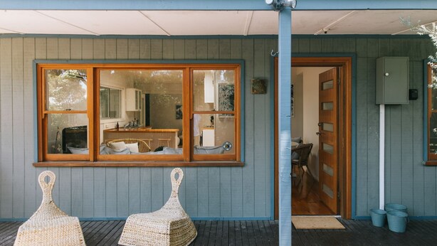 A building with a large window, a door, and two wicker chairs outside. - Dovestones by the Sea - Inverloch (Inverloch)